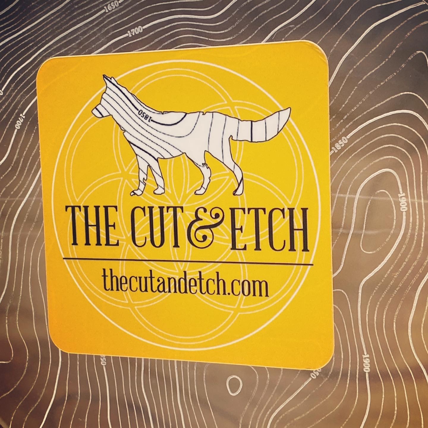 The Cut & Etch: Fine Laser Cartography for Modern Retail